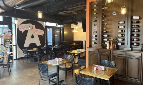 a restaurant with tables and chairs and wine